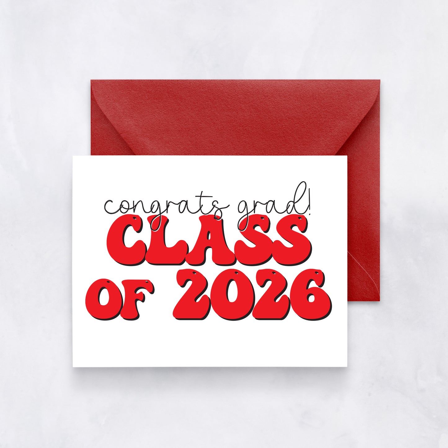 White card with “Congrats grad! Class of 2026” in red bubble letters, paired with a red envelope.