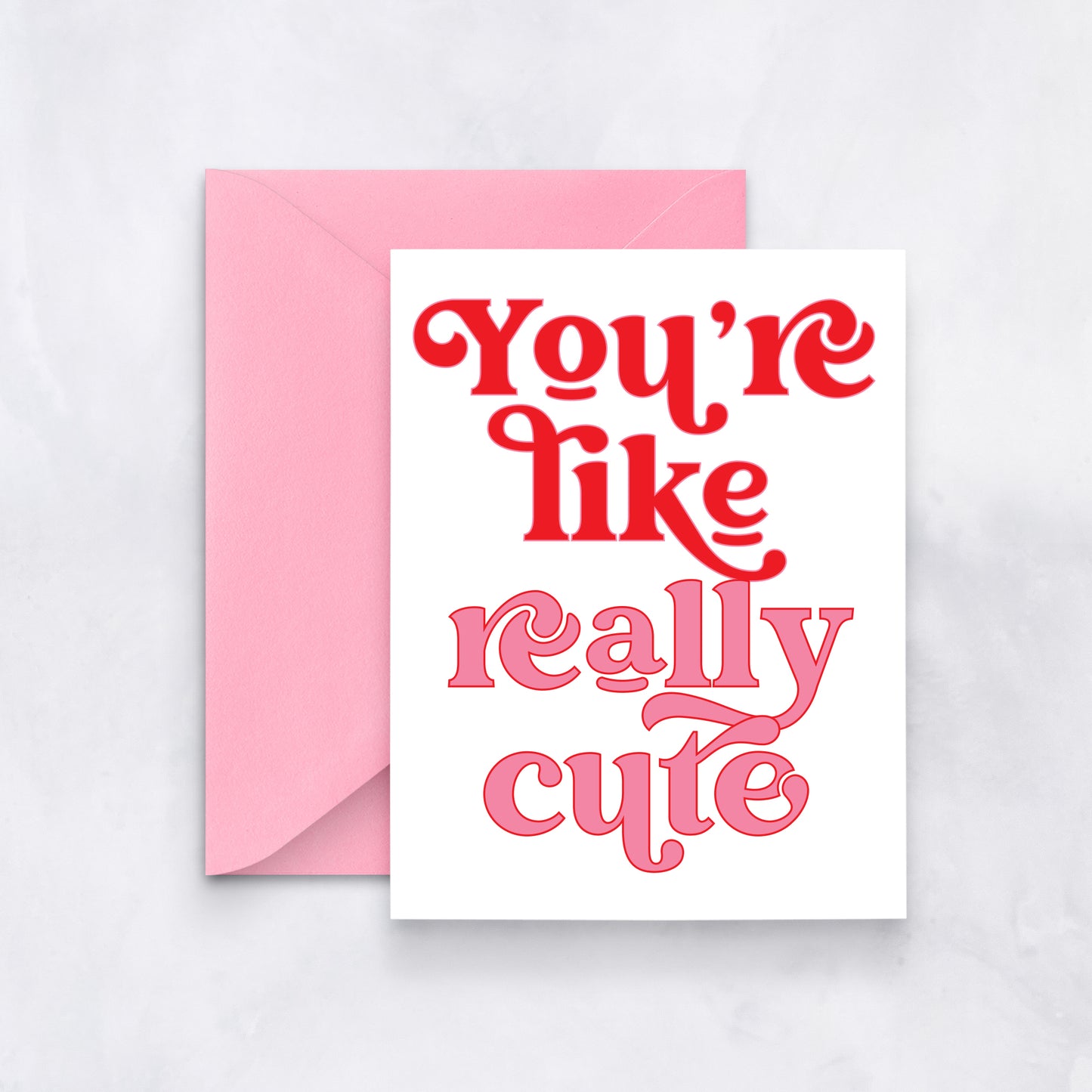 White card with bold retro pink and red text reading “You’re like really cute,” styled with a pink envelope.