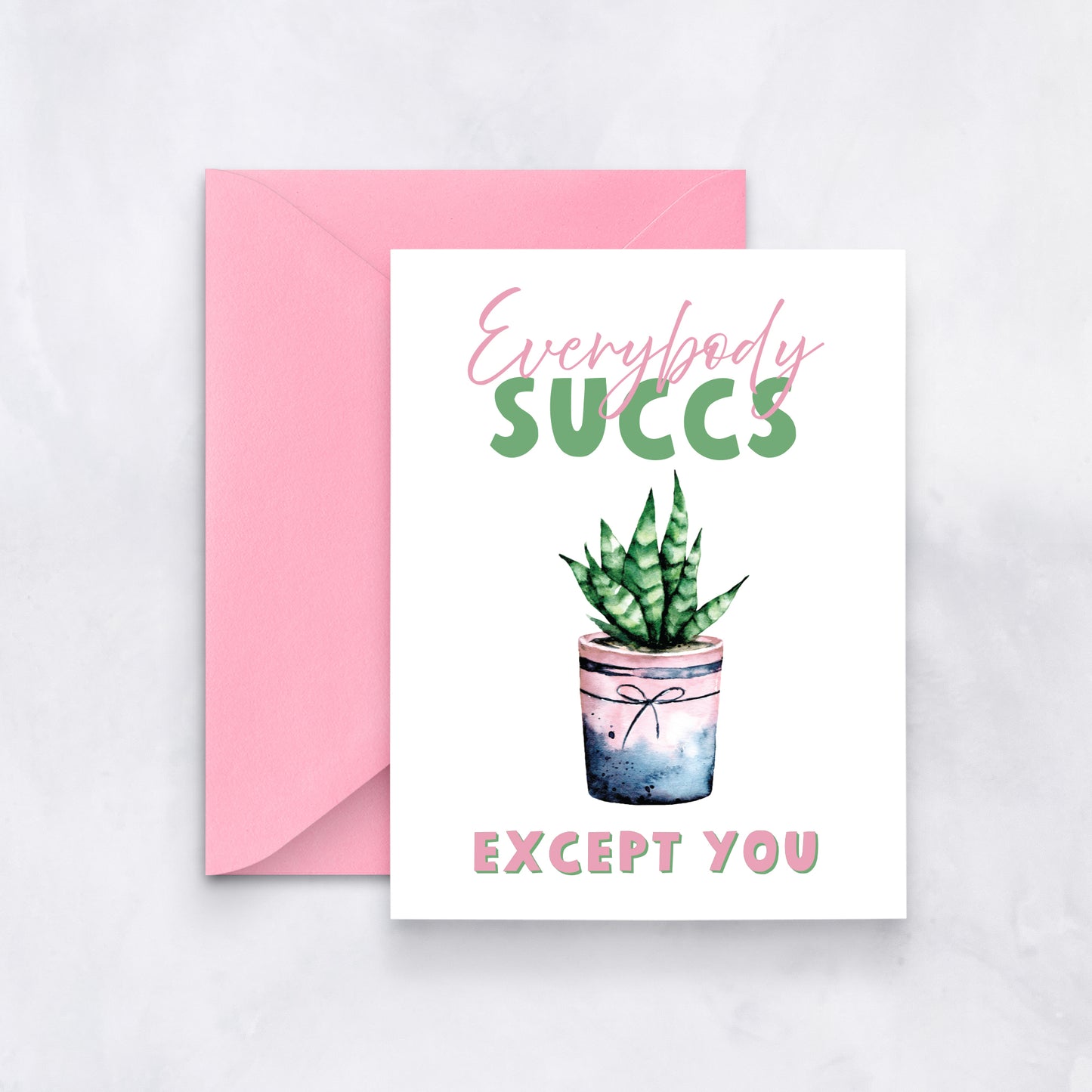 White card with watercolor succulent in pink pot, text reads “Everybody succs except you,” styled with a pink envelope.