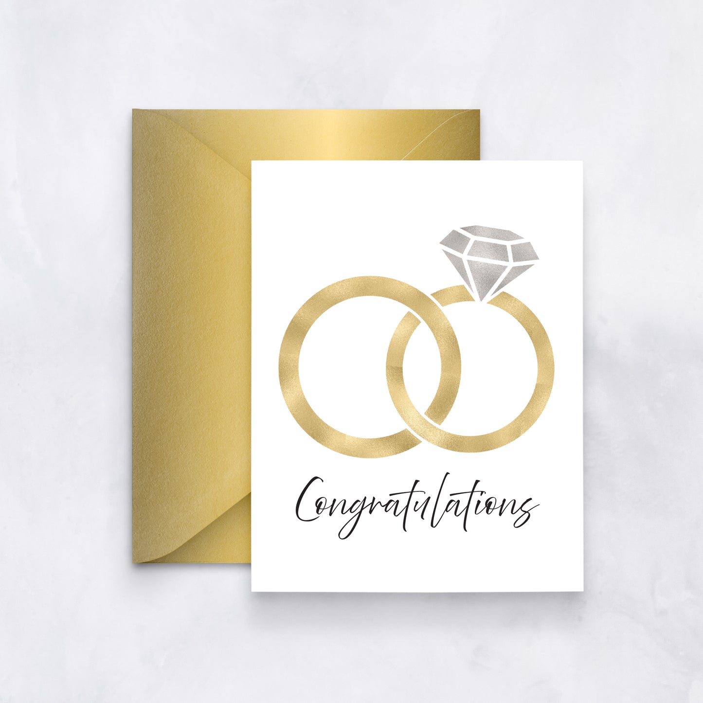 White wedding card with gold interlocking rings and diamond icon, “Congratulations” in black script, styled with a metallic gold envelope.