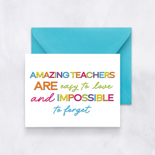White card with rainbow-colored text reading “Amazing teachers are easy to love and impossible to forget,” paired with a turquoise envelope.