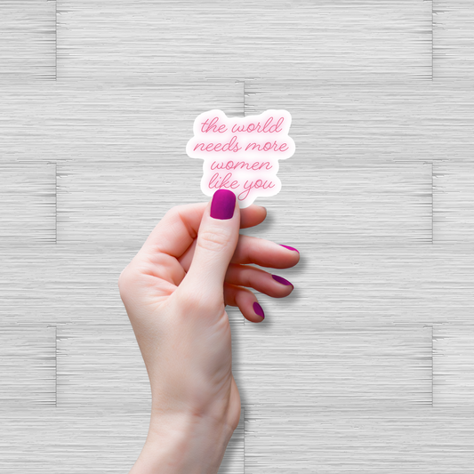 Hand holding a sticker with text on a textured gray background