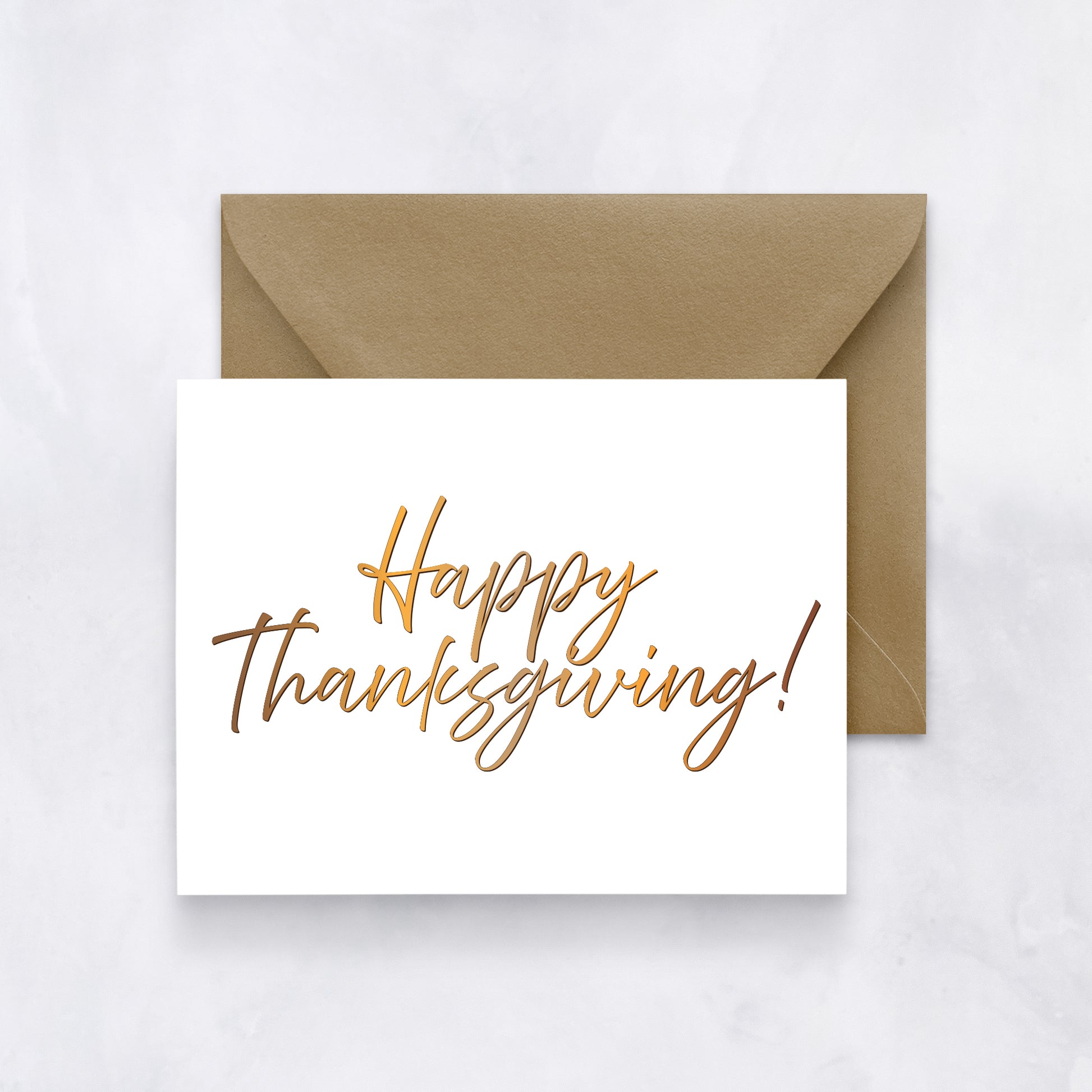 White card with “Happy Thanksgiving!” written in golden-brown script, paired with a tan envelope.