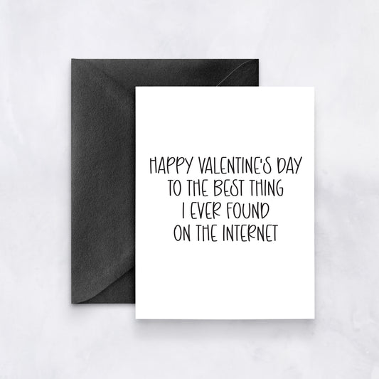 White card with black handwritten text reading “Happy Valentine’s Day to the best thing I ever found on the internet,” styled with a black envelope.