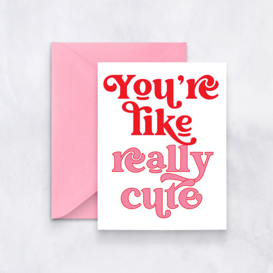 White card with bold retro pink and red text reading “You’re like really cute,” styled with a pink envelope.