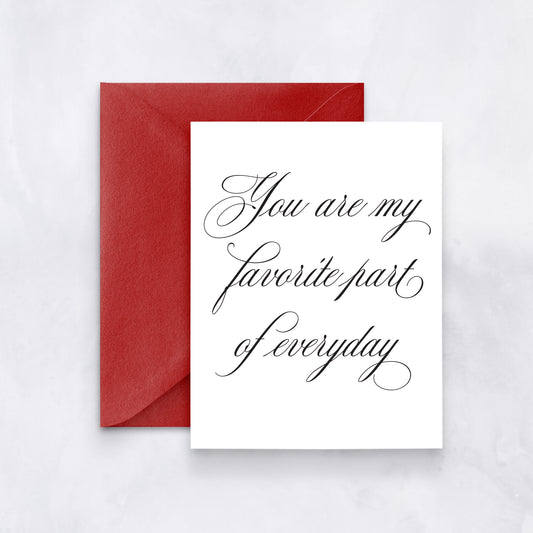 White card with elegant black script reading “You are my favorite part of everyday,” styled with a red envelope.