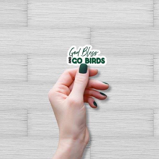 Hand holding a sticker with 'God Bless Birds' text on a textured gray background